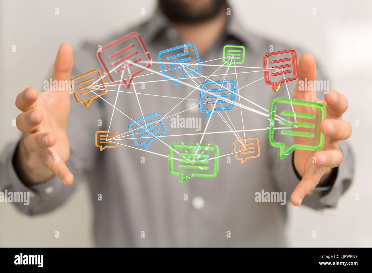 A man presenting connected message icons between his hands, a concept ...