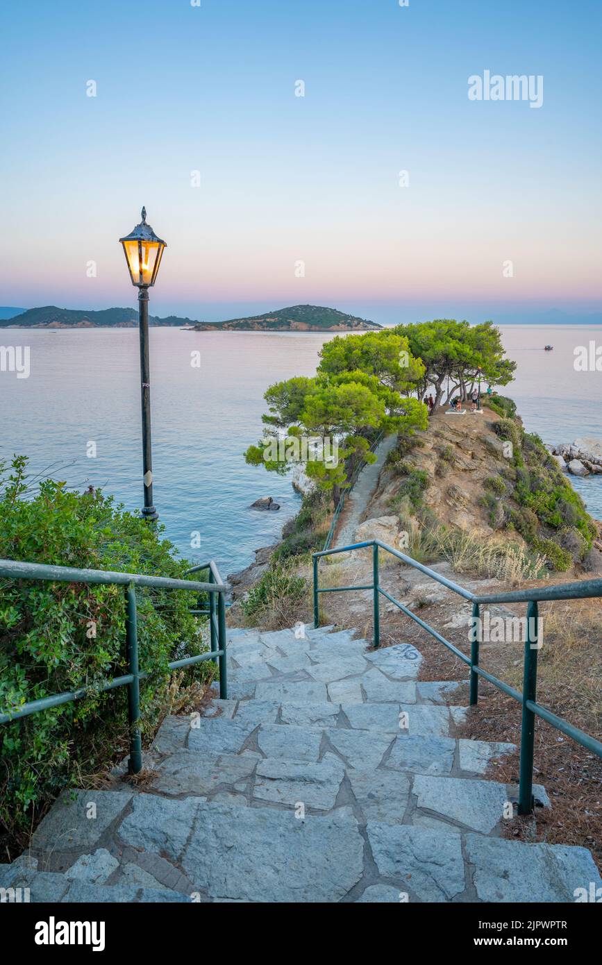 View of headland path and Aegean Sea at dusk, Skiathos Town, Skiathos Island, Sporades Islands, Greek Islands, Greece, Europe Stock Photo