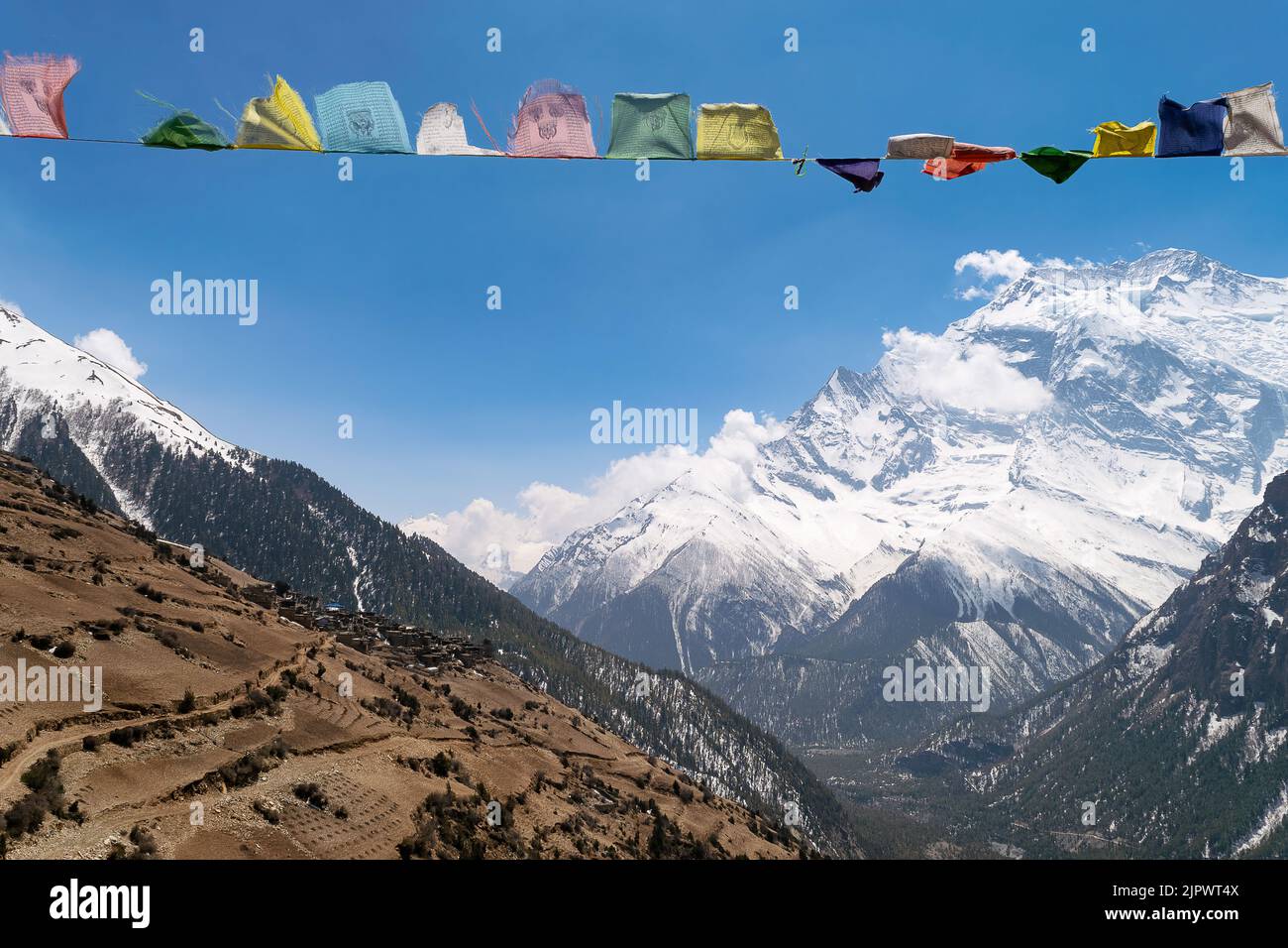 A beautiful view of a mountain landscape with laundry on wire under the blue sky Stock Photo