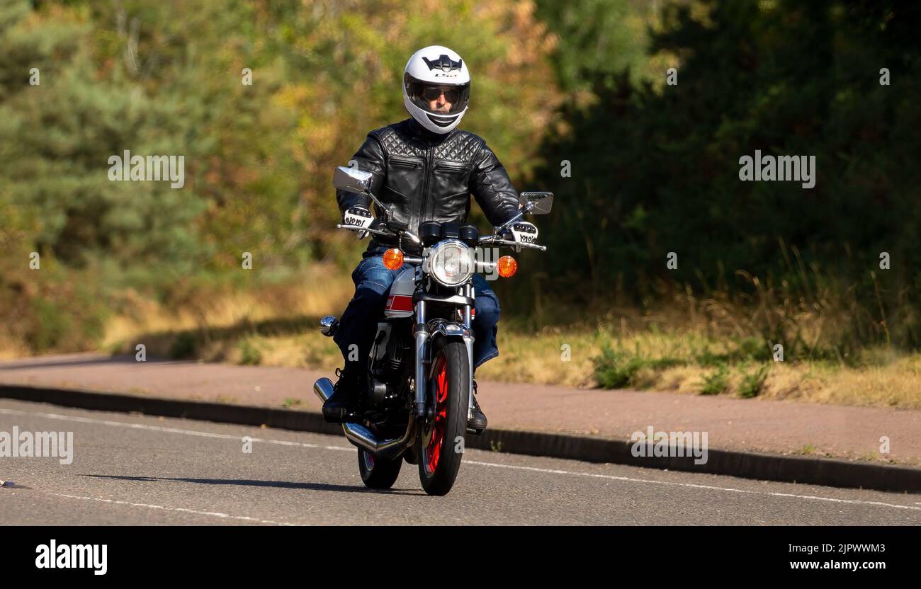 Man riding a small Yamaha motorcycle Stock Photo