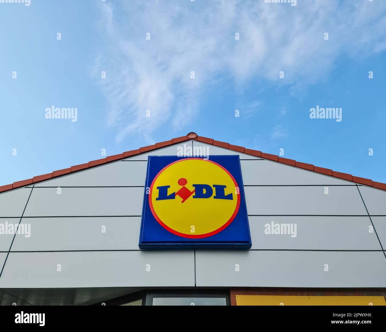 A low-angle shot of a logo of the discount store Lidl on the wall of a supermarket branch Stock Photo