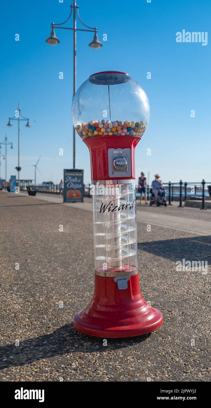 Lowestoft, Suffolk, UK – August 14 2022. Traditional gum ball machine on Lowestoft seafront on the Suffolk coast. Captured on a bright morning Stock Photo
