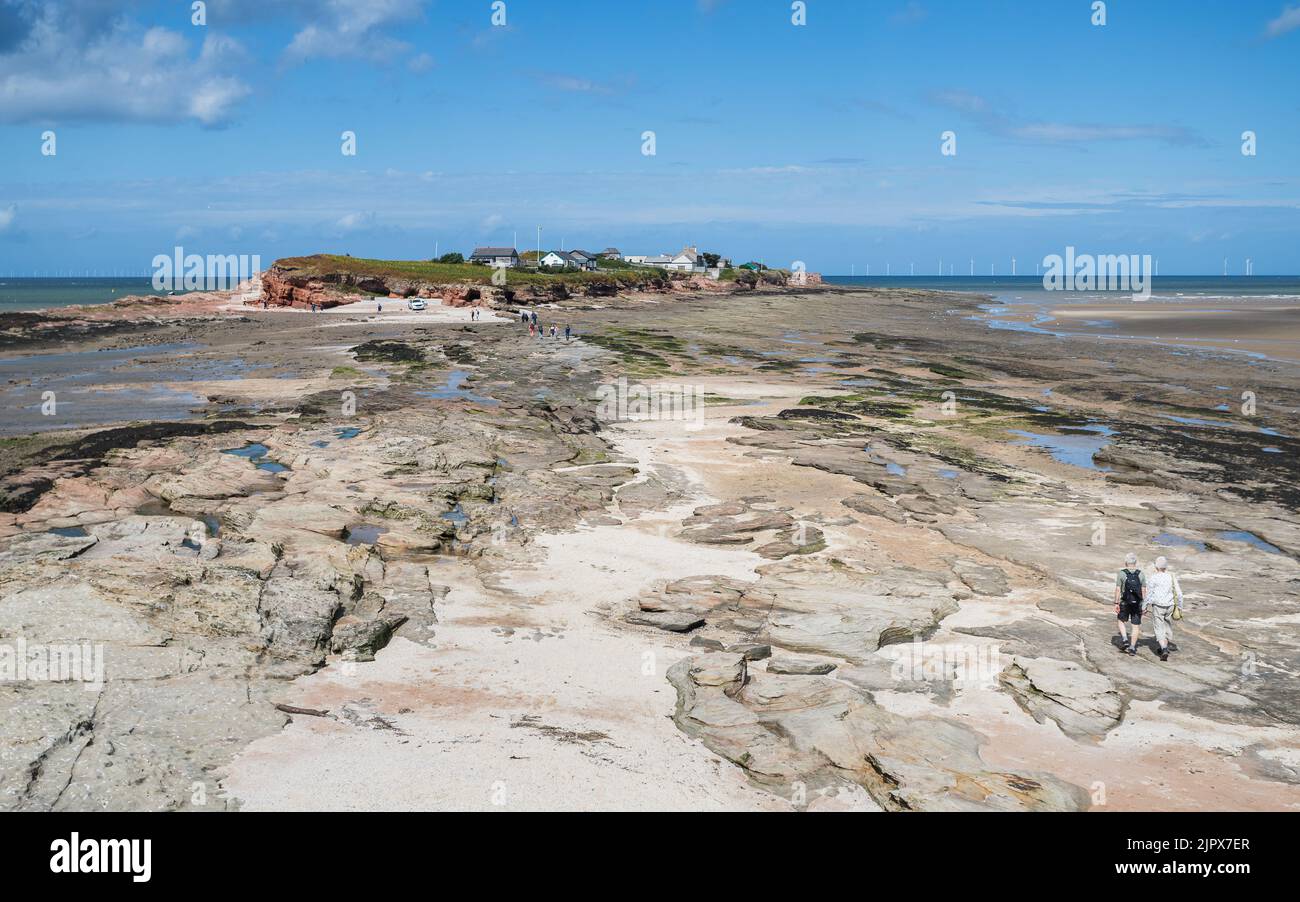 A pathway over the rocks from Middle Eye down to Hilbre Island on the Wirral Penninsula seen in August 2022. Stock Photo