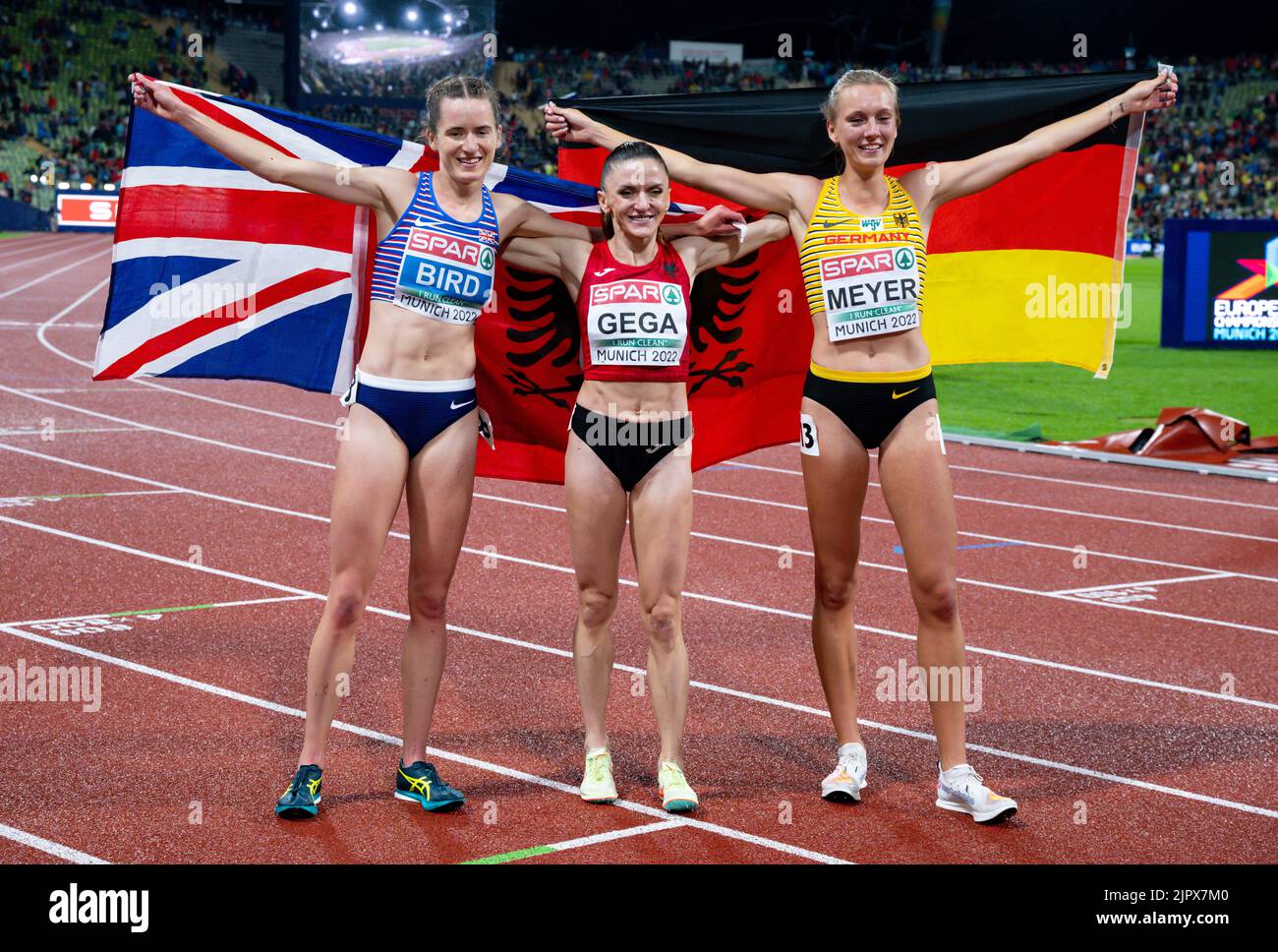 Munich, Germany. 20th Aug, 2022. European Championships, Athletics, 3000m steeplechase, women, final at Olympic Stadium, Elizabeth Bird (l-r) of Great Britain, Luiza Gega of Albania, Lea Meyer of Germany cheer at the finish line. Credit: Sven Hoppe/dpa/Alamy Live News Stock Photo