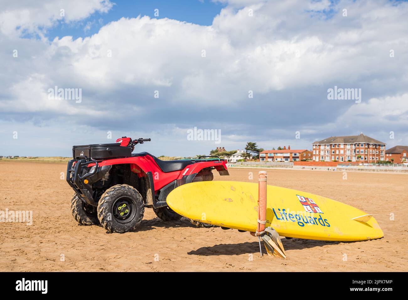 RNLI paddle board and quad bike seen on the beach at West Kirby on the Wirral penninsula seen in August 2022. Stock Photo