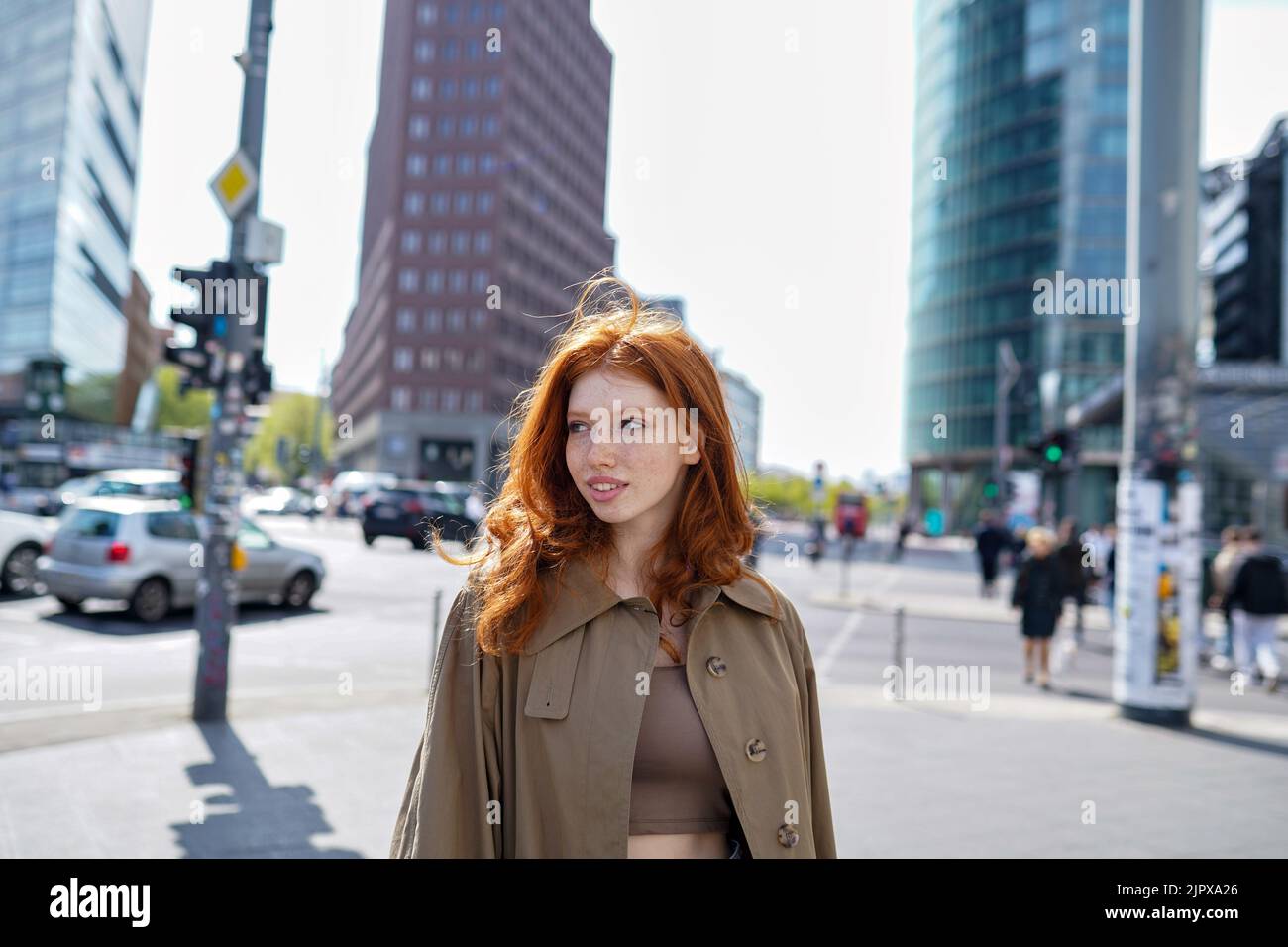 Redhead teenage hipster girl standing on big city street. Stock Photo