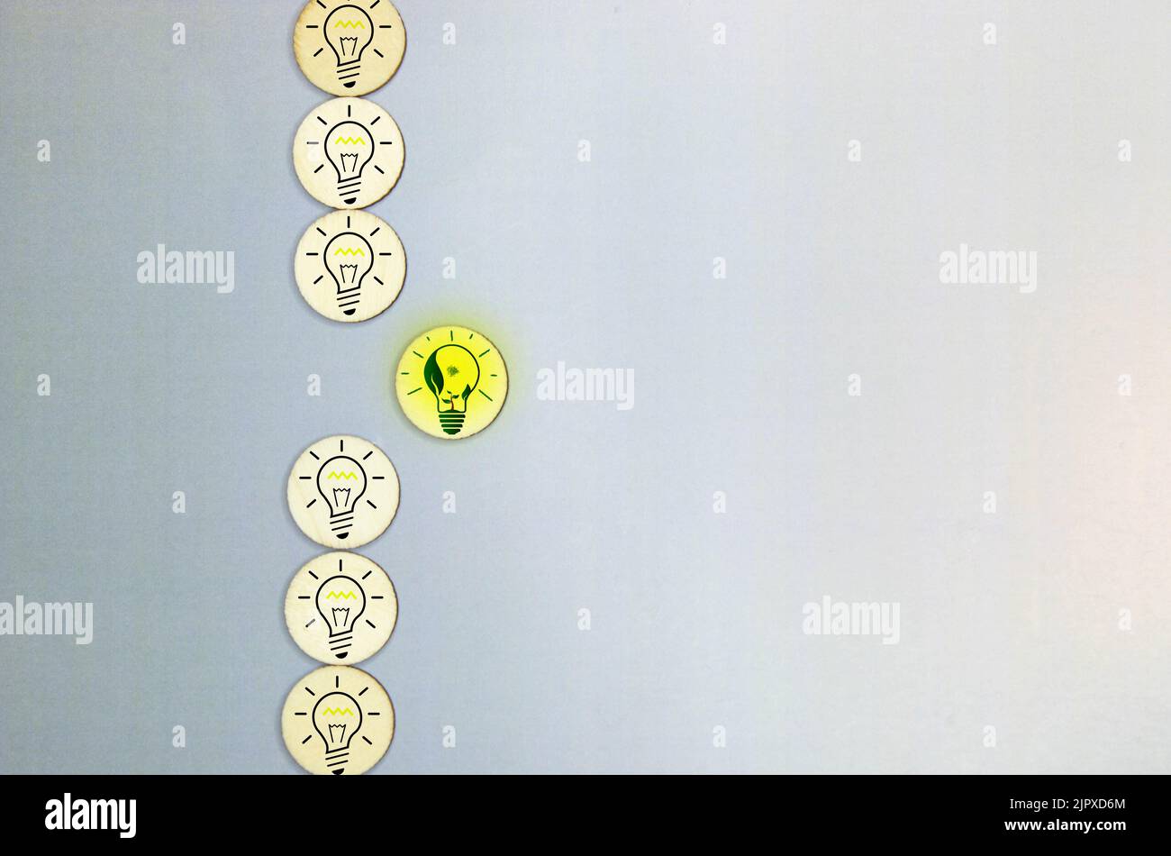 Incandescent light bulb in a row with middle fluorescent light bulb on. Concept for energy