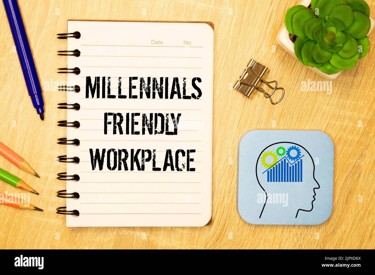 Closeup on businessman holding a card with text MILLENNIALS FRIENDLY WORKPLACE , business concept image with soft focus background and vintage tone Stock Photo