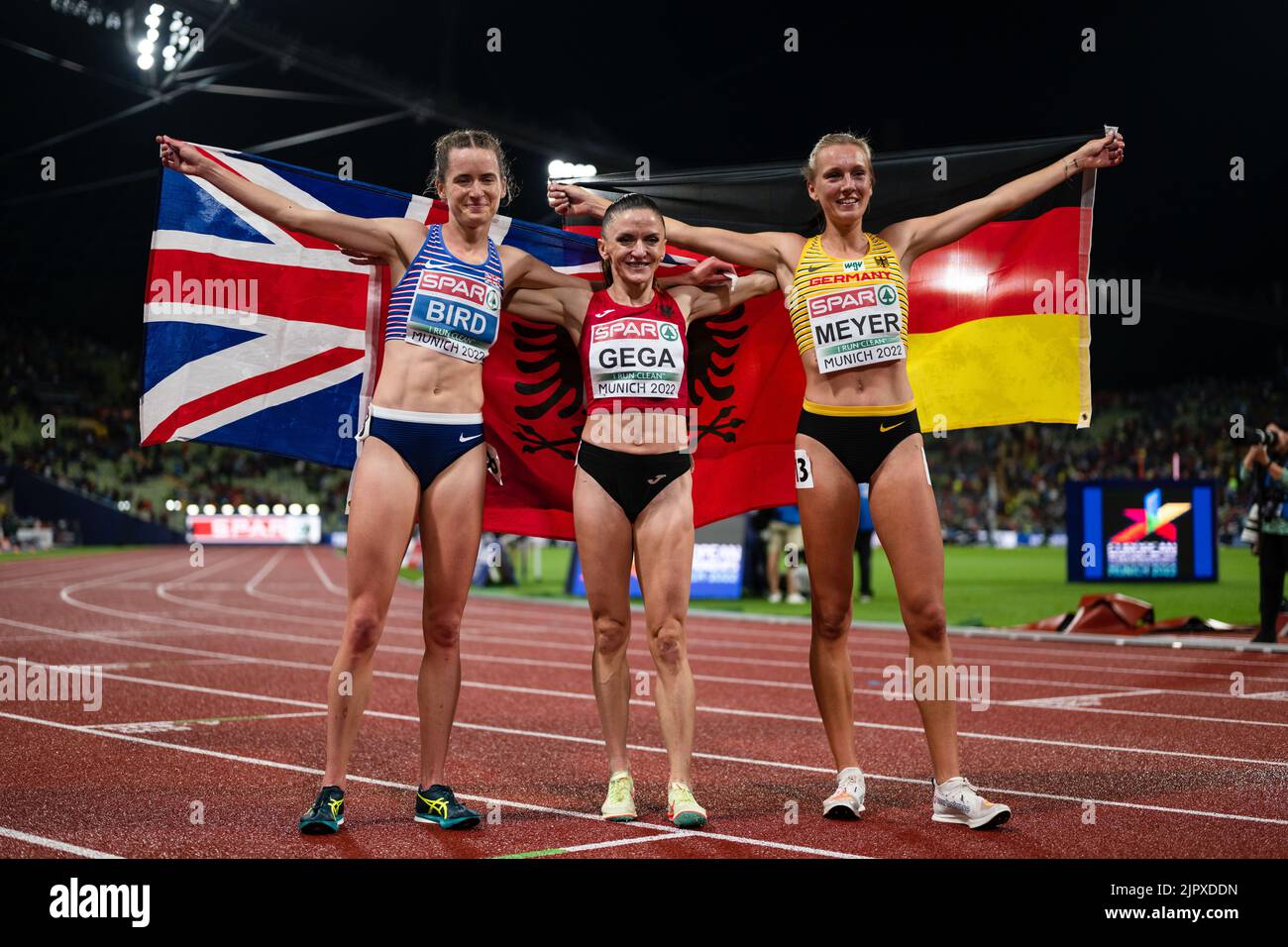Munich, Germany. 20th Aug, 2022. Athletics: European Championships, Olympic Stadium, 3000m steeplechase, women, final. Third-placed Elizabeth Bird (Great Britain), first-placed Luiza Gega (Albania) and second-placed Lea Meyer (Germany) cheer at the finish line. Credit: Marius Becker/dpa/Alamy Live News Stock Photo