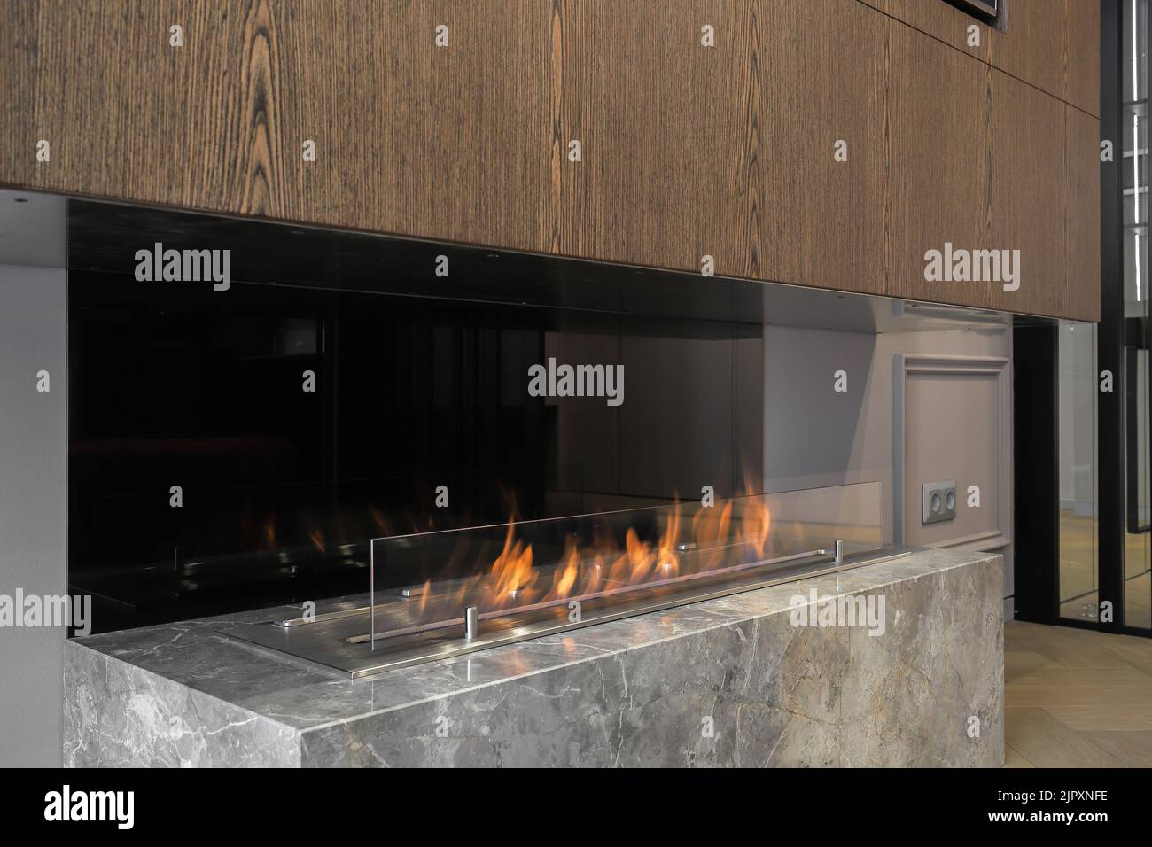 Burning eco bio fireplace in the modern apartment interior Stock Photo