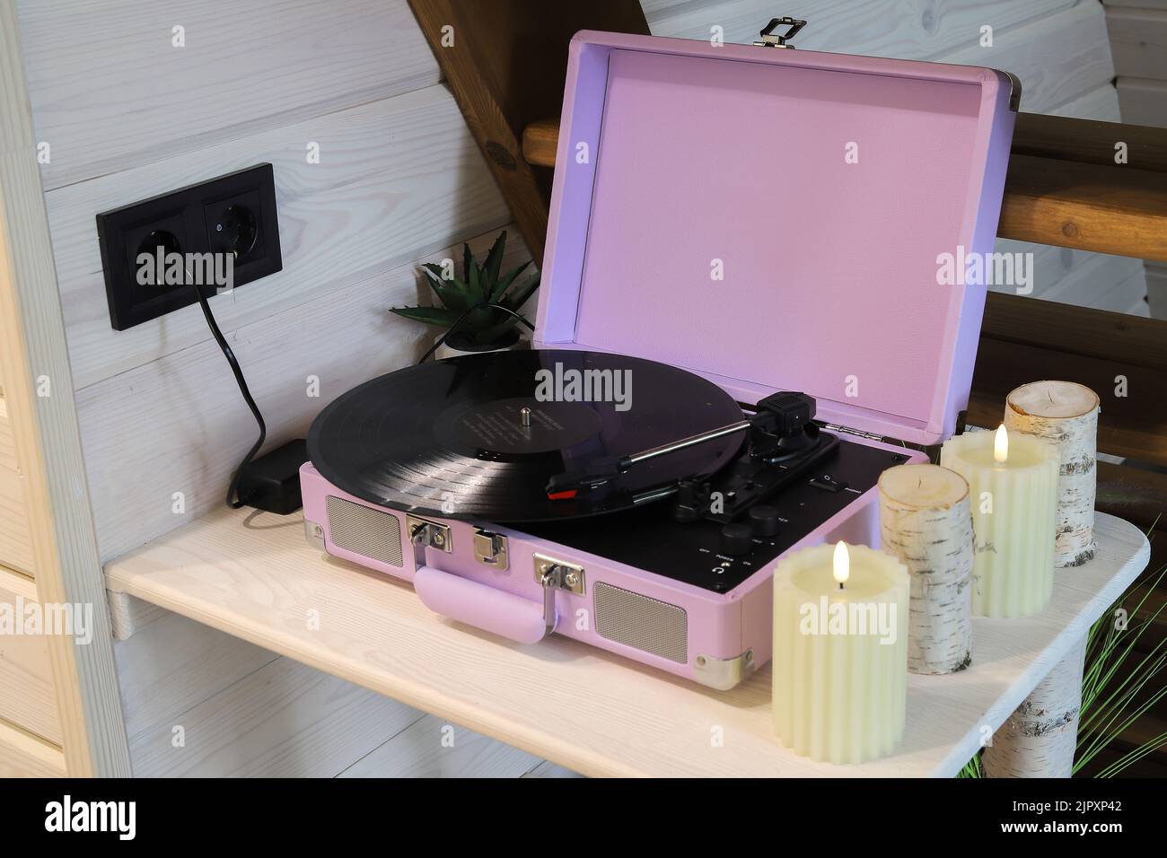 Pink vinyl record player on the table Stock Photo