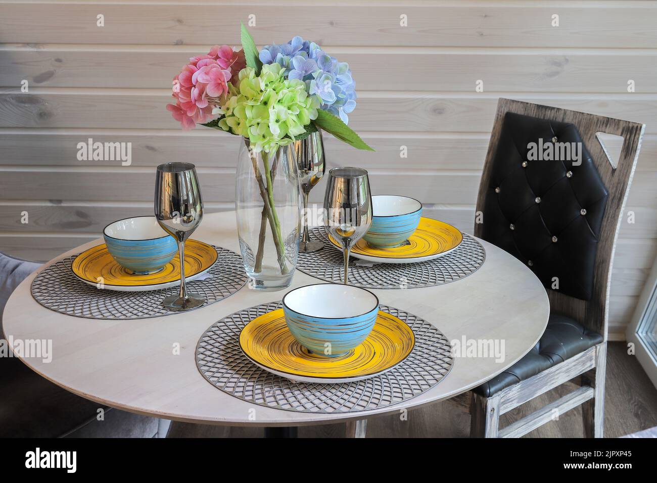 Round dining table in a modern interior design Stock Photo - Alamy