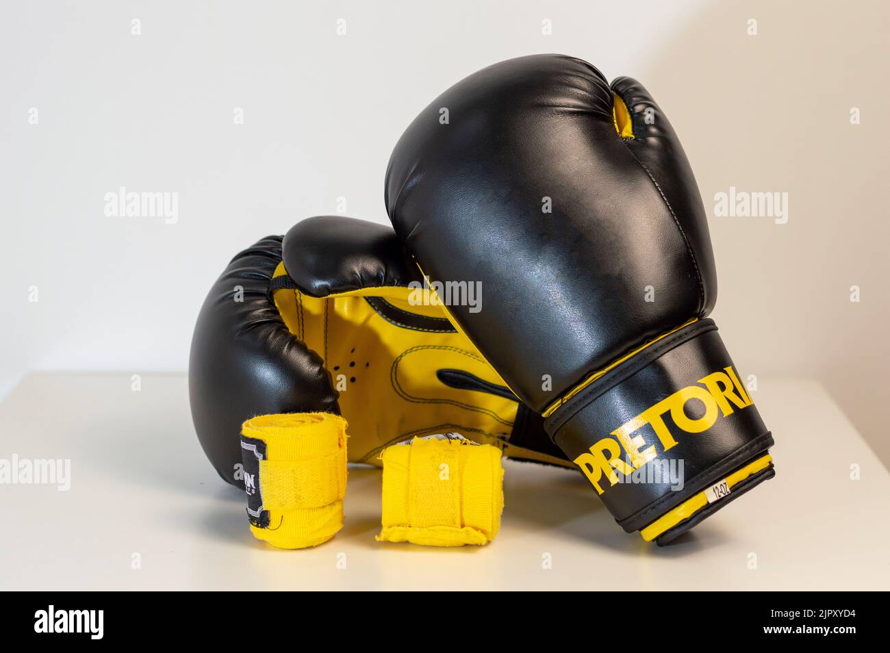 CloseUp Of Black Boxing Gloves Against White Background. Pair of black