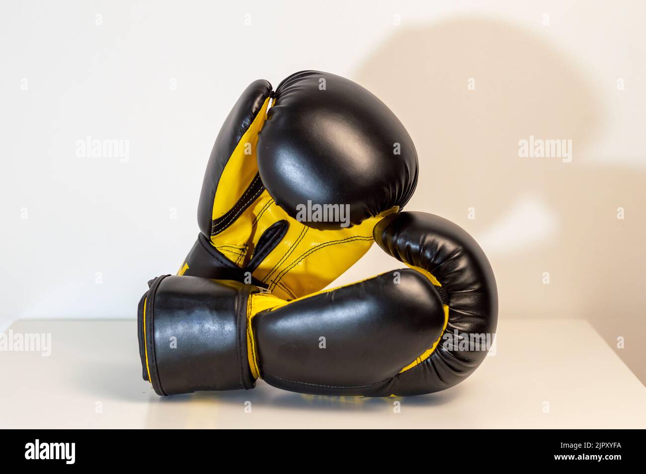 CloseUp Of Black Boxing Gloves Against White Background. Pair of black