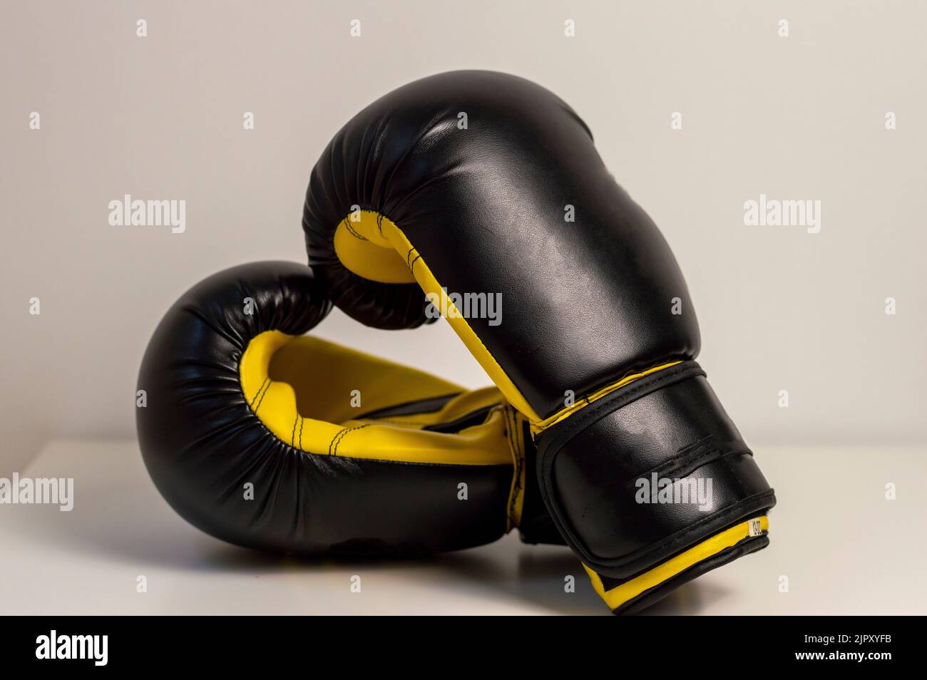 CloseUp Of Black Boxing Gloves Against White Background. Pair of black