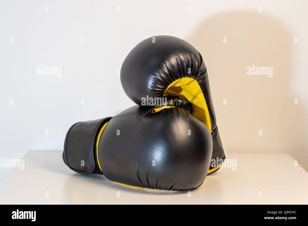 CloseUp Of Black Boxing Gloves Against White Background. Pair of black