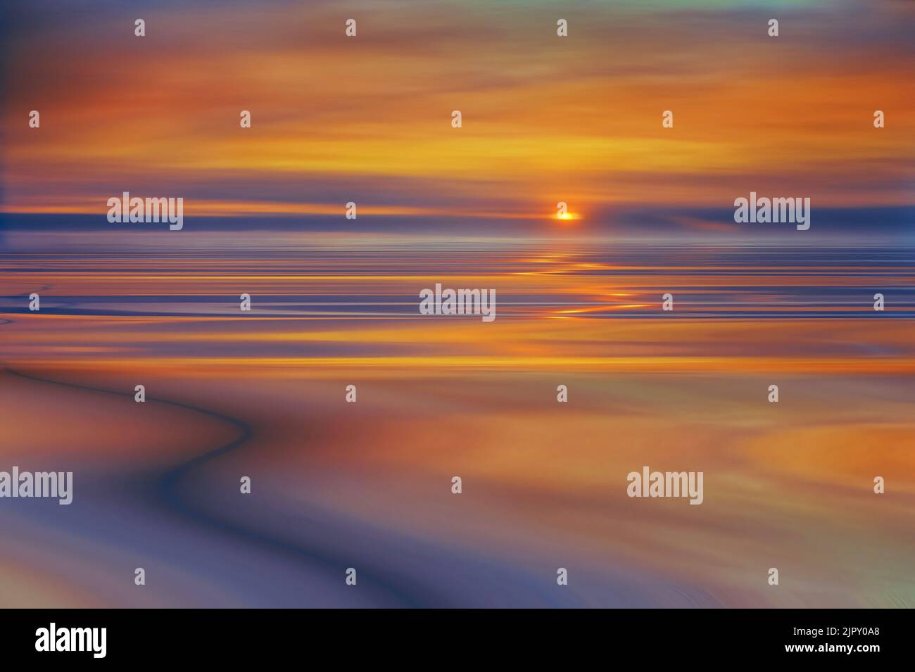 The sun setting behind warm clouds and smooth, silky water Stock Photo