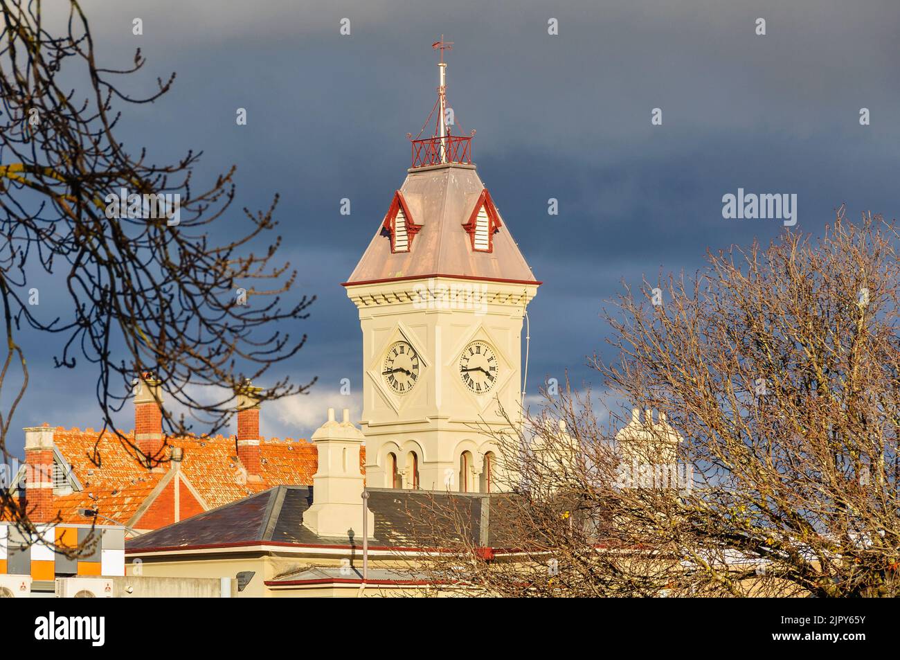 The clock tower of the Post Office lit by bright afternoon autumn sunshine - Kyneton, Victoria, Australia Stock Photo