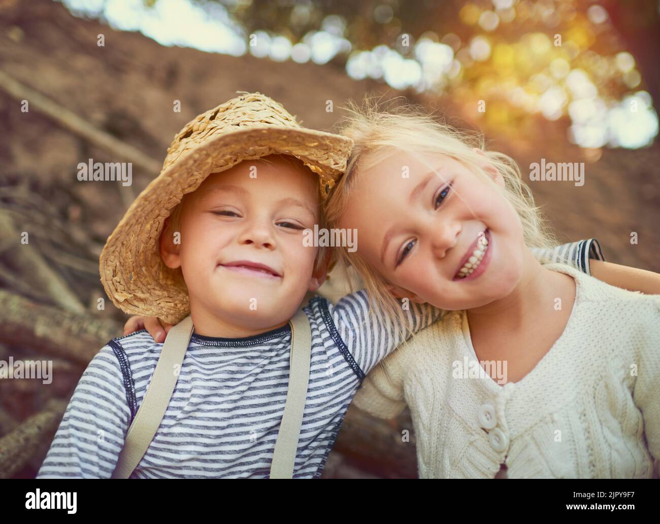 Having fun is our rule number one. Portrait of two little children playing together outdoors. Stock Photo