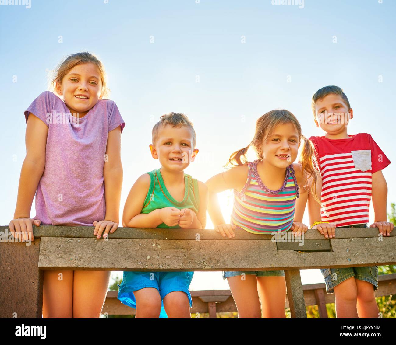 Having a bunch of fun in the summer sun. Portrait of a group of little children playing together outdoors. Stock Photo
