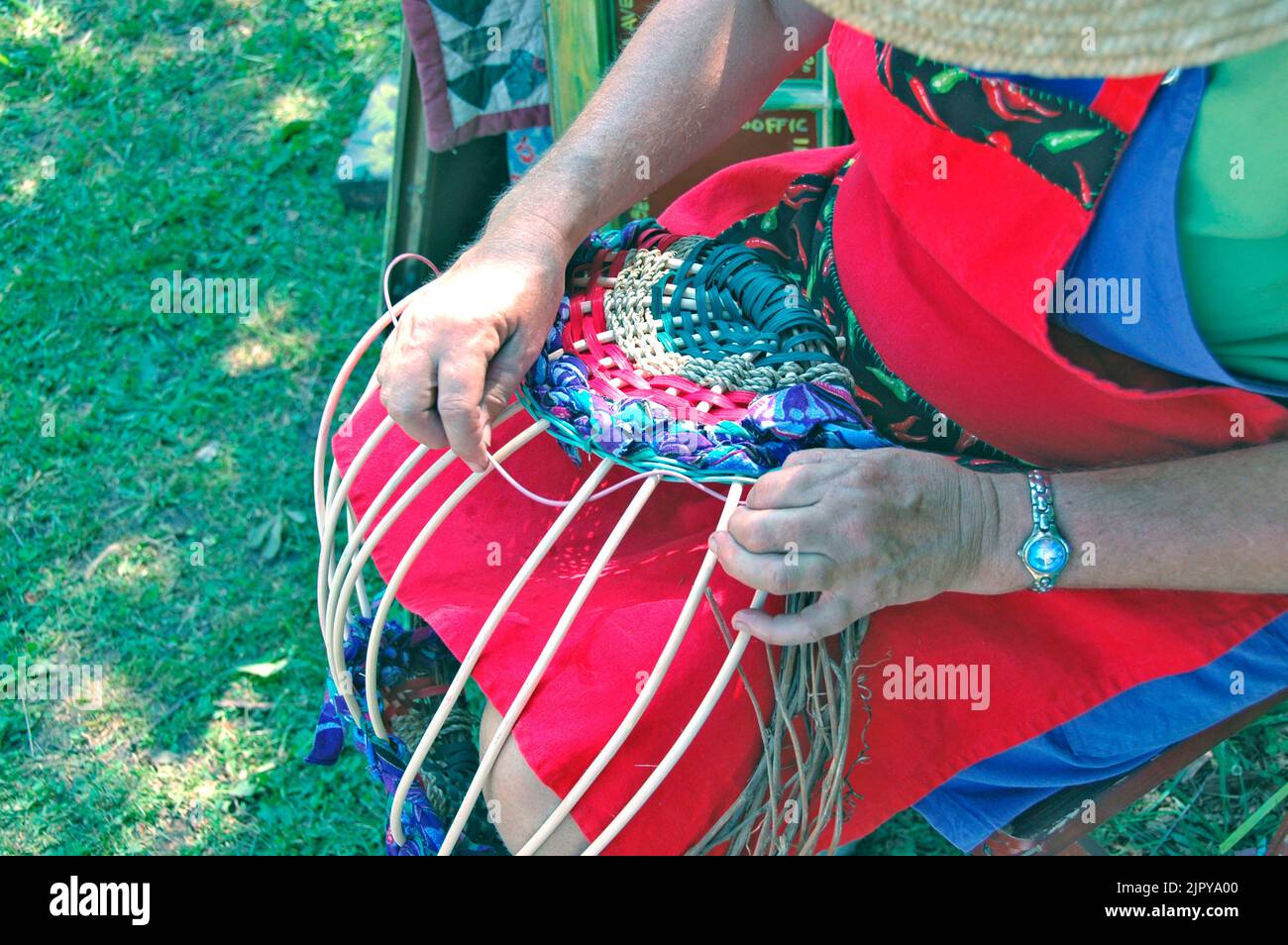 Hands working at an arts and crafts show making crafts and art weaving for sale Stock Photo