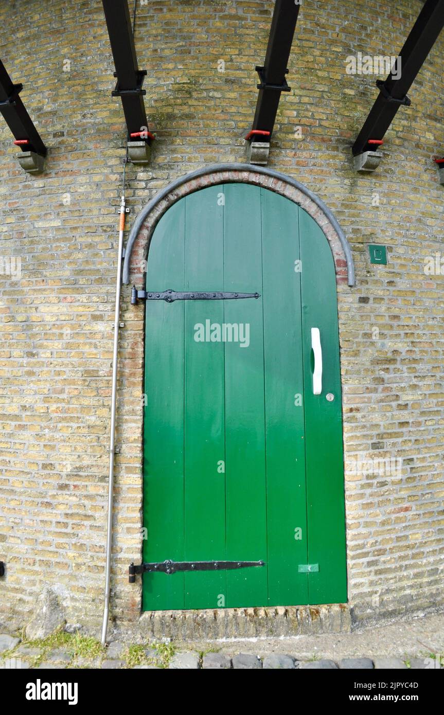 A mysterious green door smells of worlds unexplored. Stock Photo