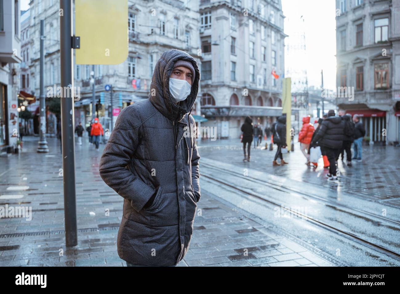 man wearing face mask waiting for the tram Stock Photo