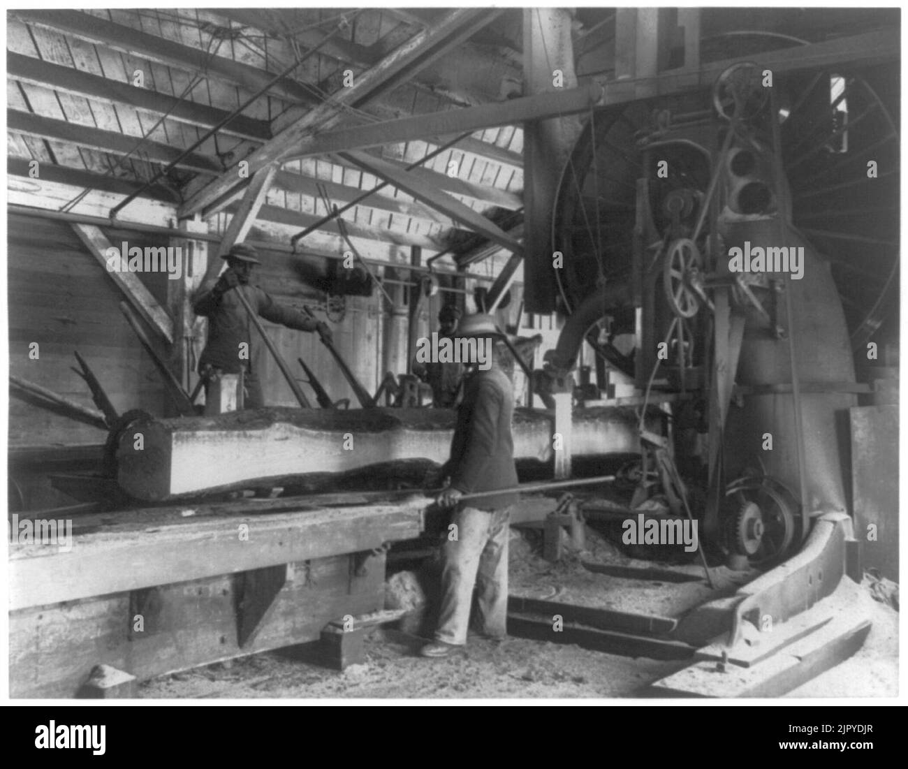 Three young black men working in lumber mill at Hampton Institute
