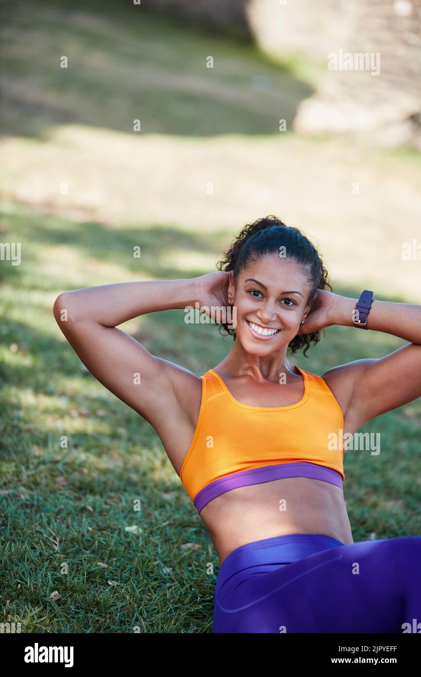 Youre only as strong as think. a sporty young woman doing sit ups as ...