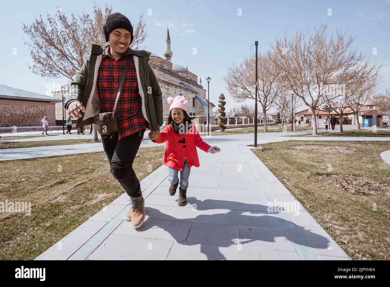 Run With Daughter Rfds father running around with daughter while playing in city square Stock ...