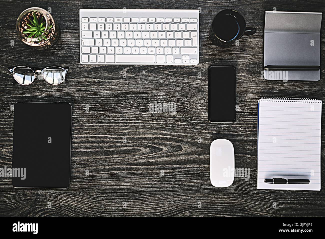 The wireless way to work. High angle shot of a variety of wireless devices on a work desk. Stock Photo