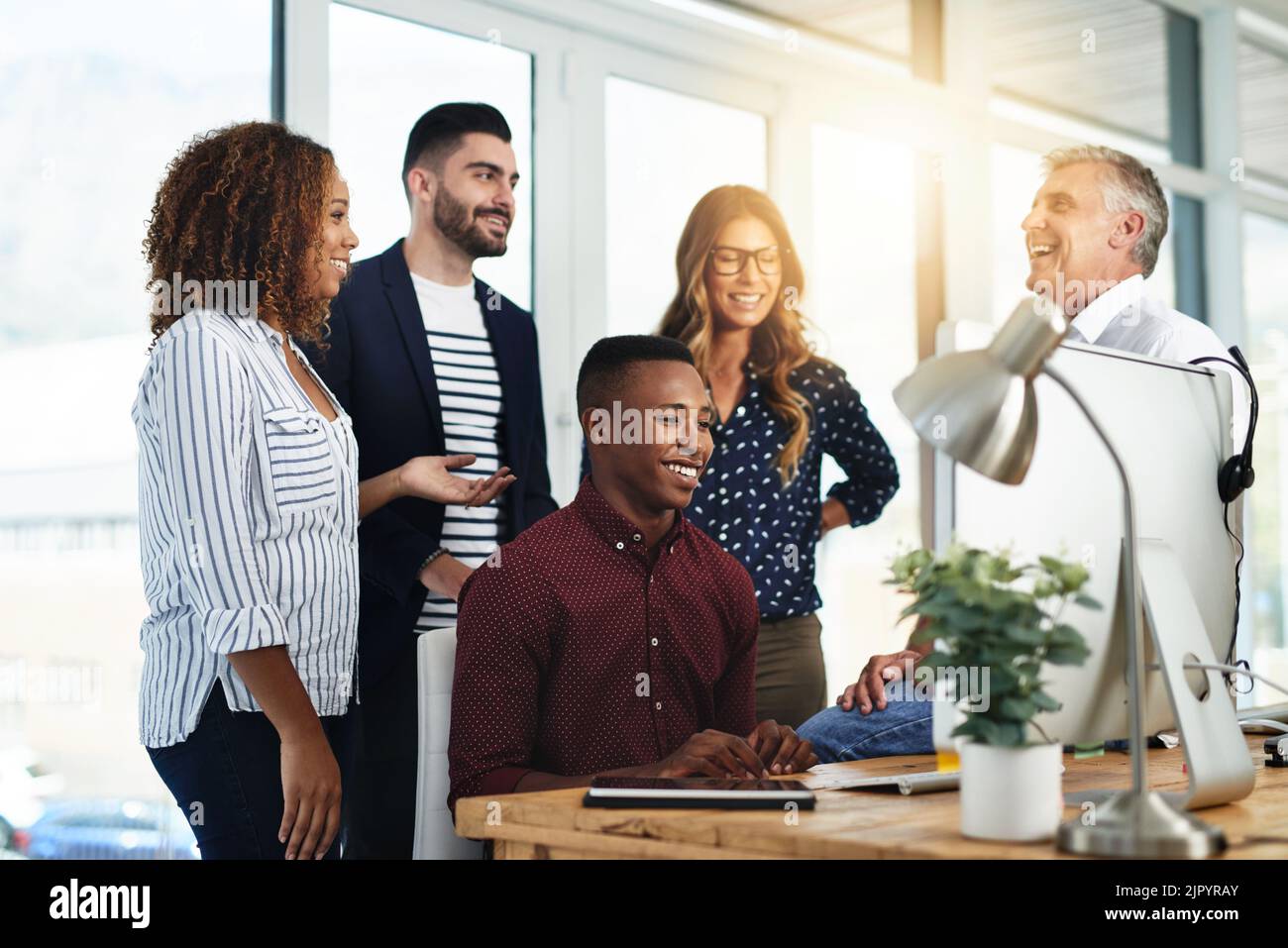 Collaboration has always been an important part of business. a group of designers working together. Stock Photo