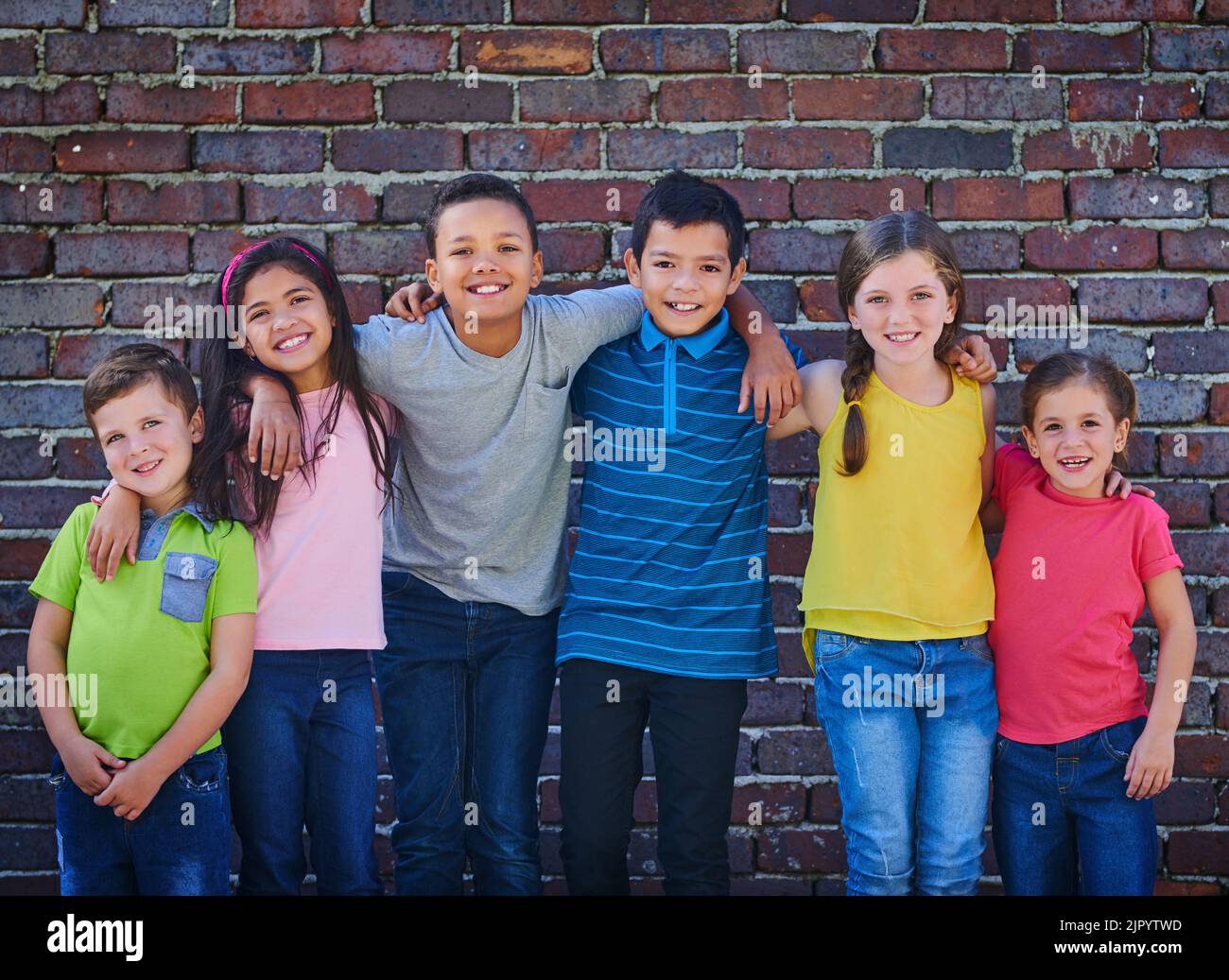 Best friends forever. a diverse group of children holding each other outside. Stock Photo