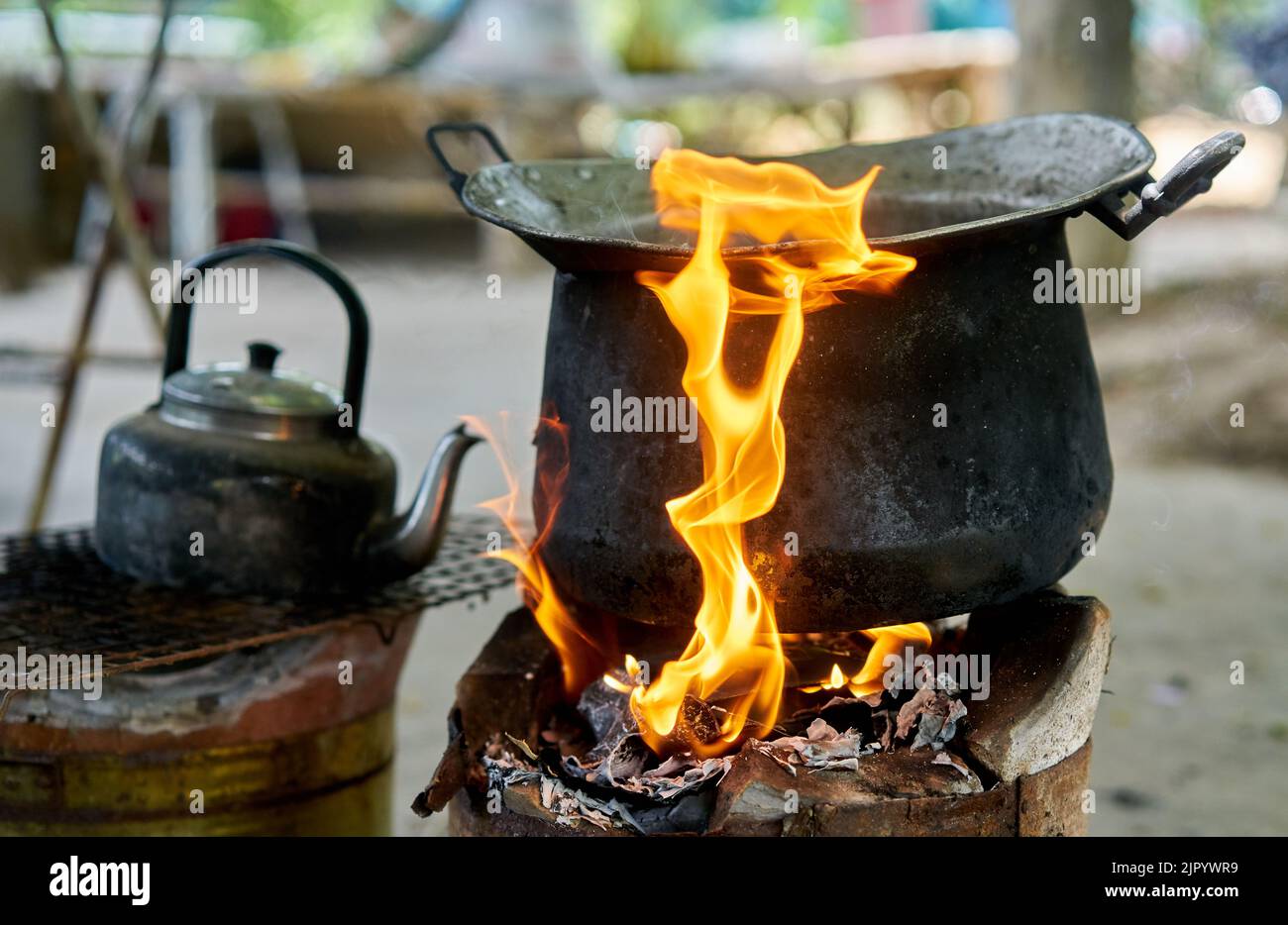 A big black pot and old kettle on an outdoor fire. Stock Photo