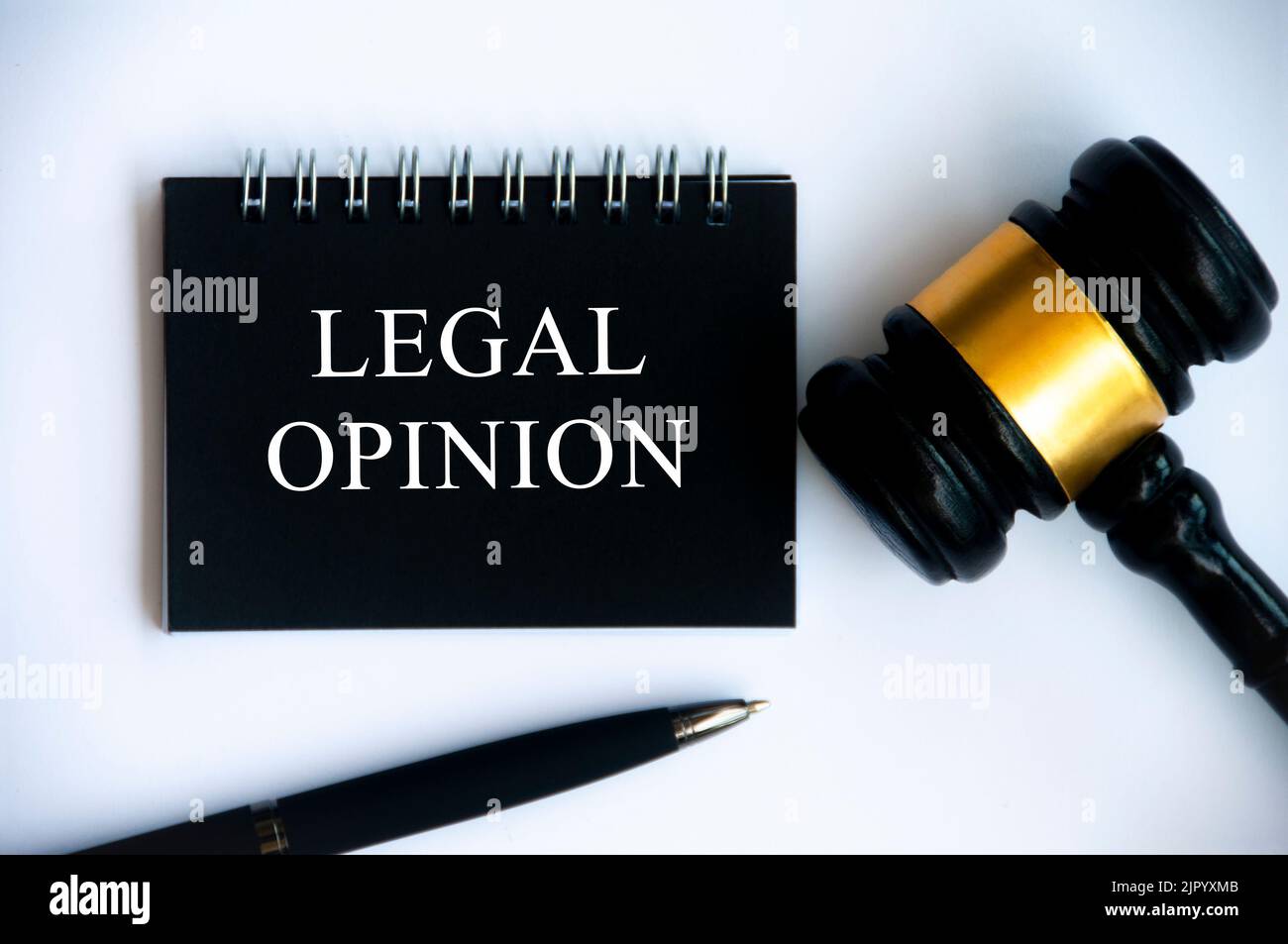 Legal opinion text on black notepad with gavel on white background. Legal and law concept. Stock Photo