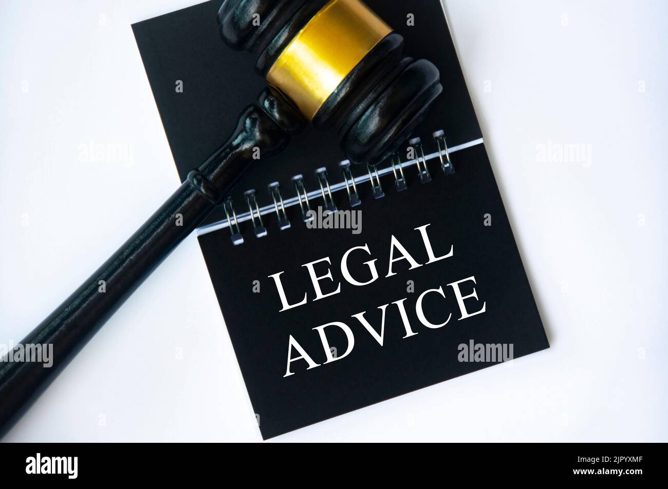 Legal advice text on black notepad with gavel on white background. Legal and law concept. Stock Photo