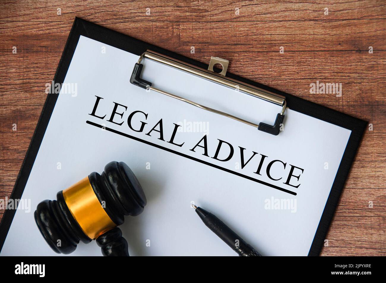 Legal advice text on white paper on a clipboard with gavel and pen. Legal and law concept. Stock Photo