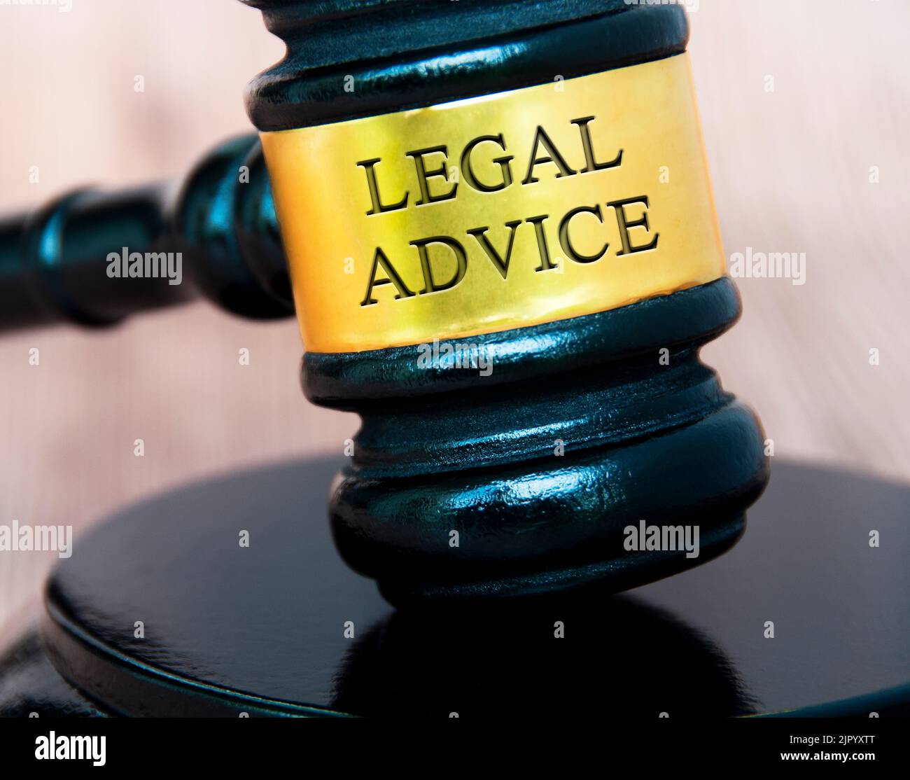 Legal advice text engraved on lawyer gavel with blurred wooden background. Legal and law concept. Stock Photo