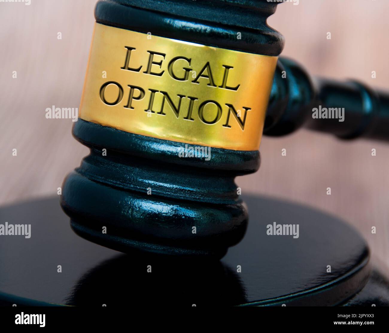 Legal opinion text engraved on lawyer gavel with blurred wooden background. Legal and law concept. Stock Photo