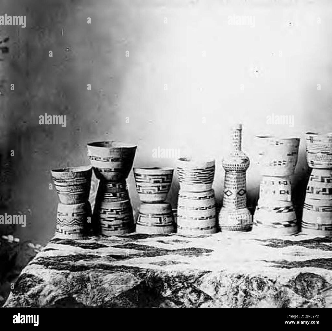 Tlingit spruce root baskets displayed on fur-covered table, circa 1910 (AL+CA 4813) Stock Photo