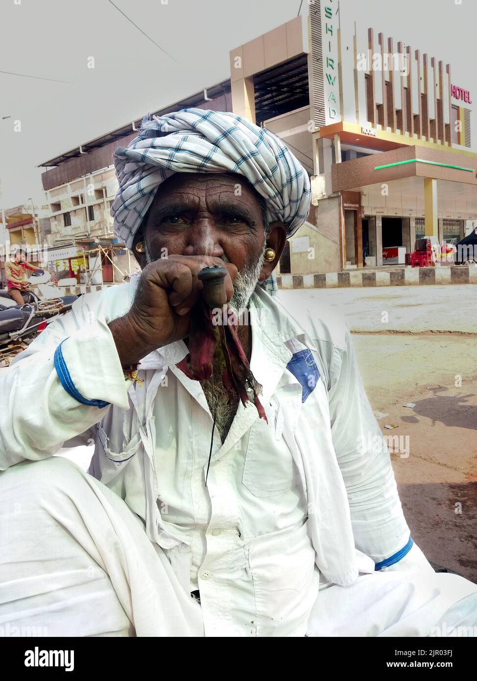 old Rajasthan man wearing traditional dress and smoking chillum Stock Photo