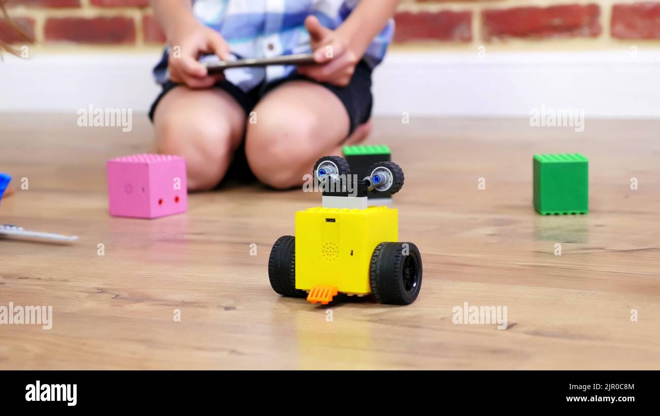 closeup, radiocontrolled robot moves on floor, little geniuses