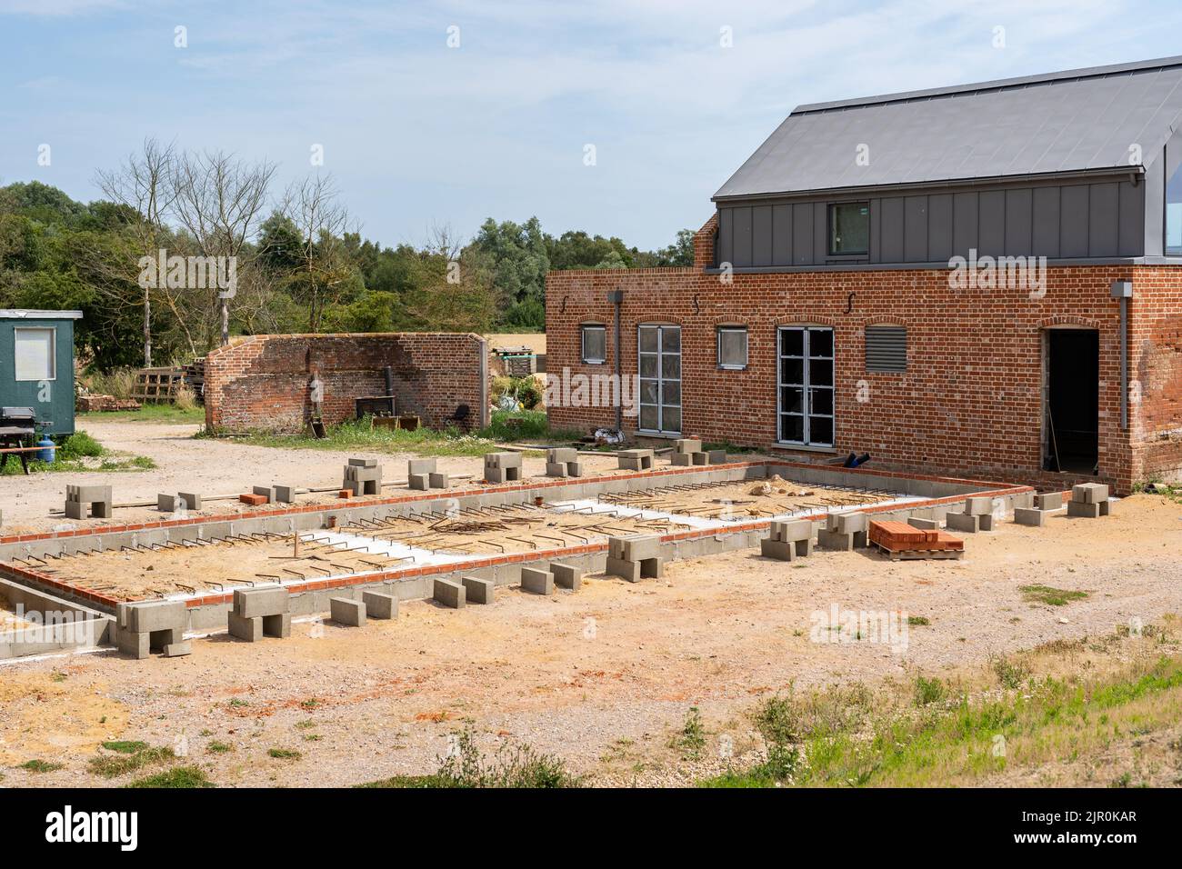 An old barn and stables that are in the middle of getting converted into a modern family home Stock Photo