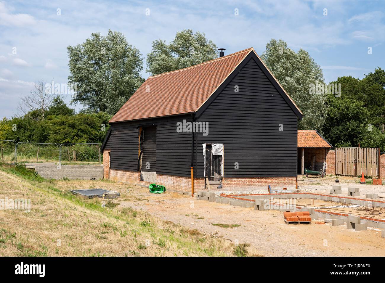 An old barn and stables that are in the middle of getting converted into a modern family home Stock Photo