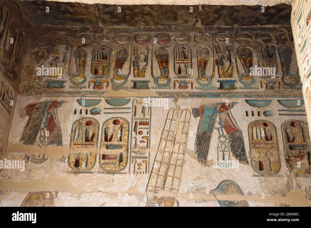 well-preserved colorful reliefs at the mortuary temple of Ramses III (Medinet Habu) at the west bank of river Nile in Luxor Stock Photo