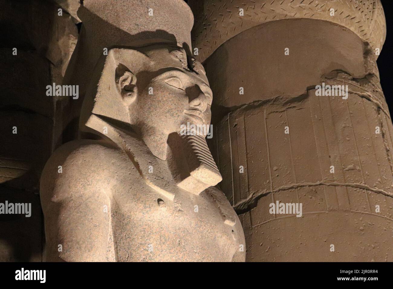 pharaoh statue in Luxor temple at night Stock Photo - Alamy