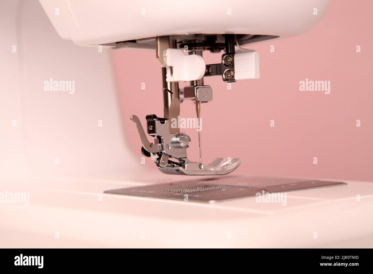 Composition from a sewing machine. Mannequin, flowers on a retro table