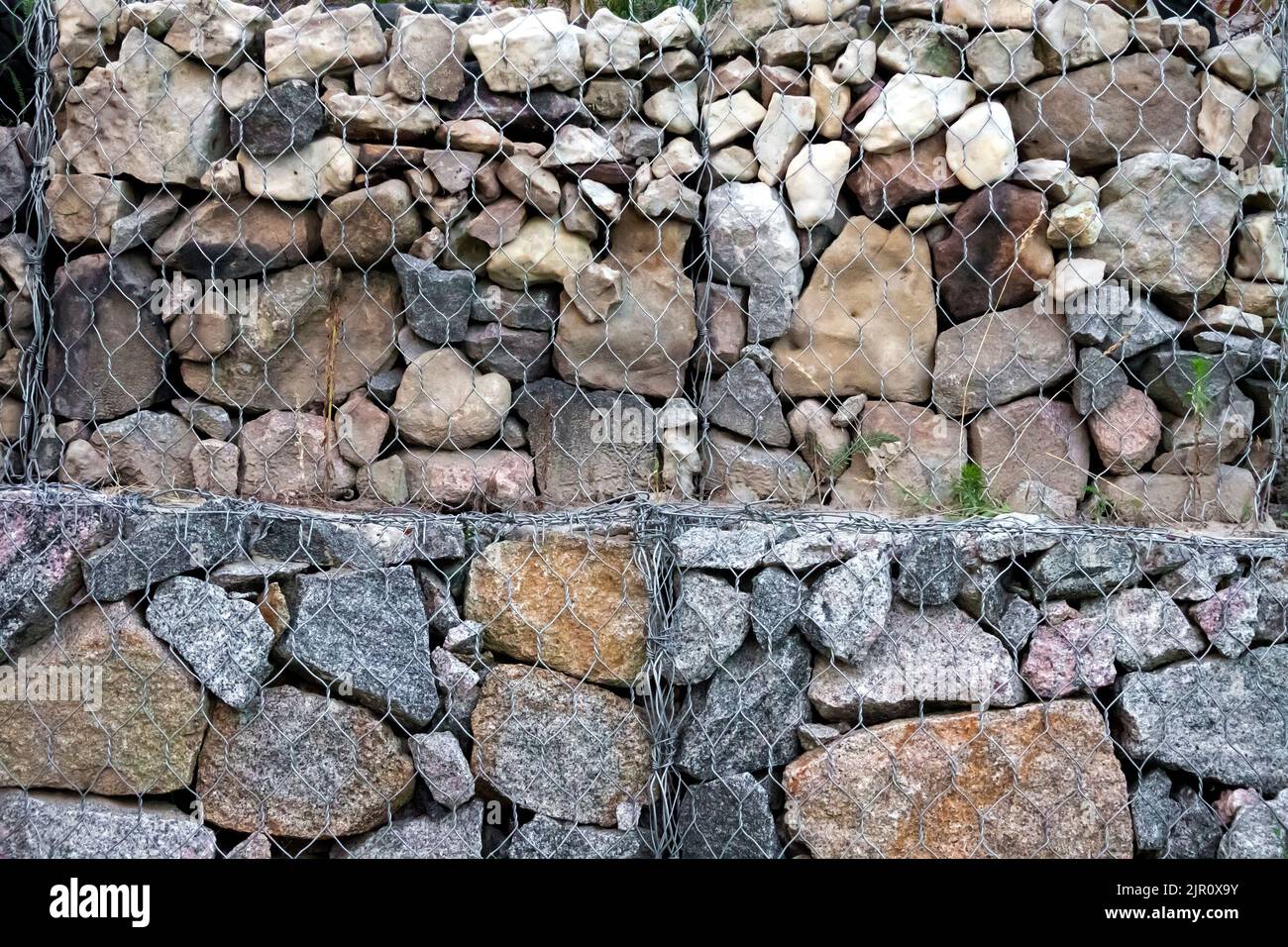 Gabion wall - stones in wire mesh used for erosion control and slope reinforcement Stock Photo