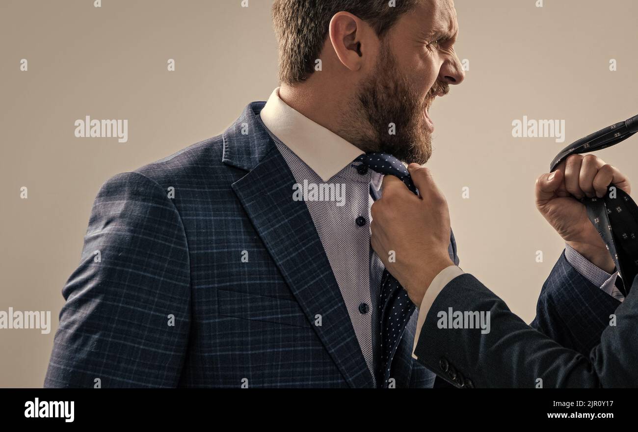 Experiencing aggression at work. Angry professional man fight with colleague. Workplace aggression Stock Photo
