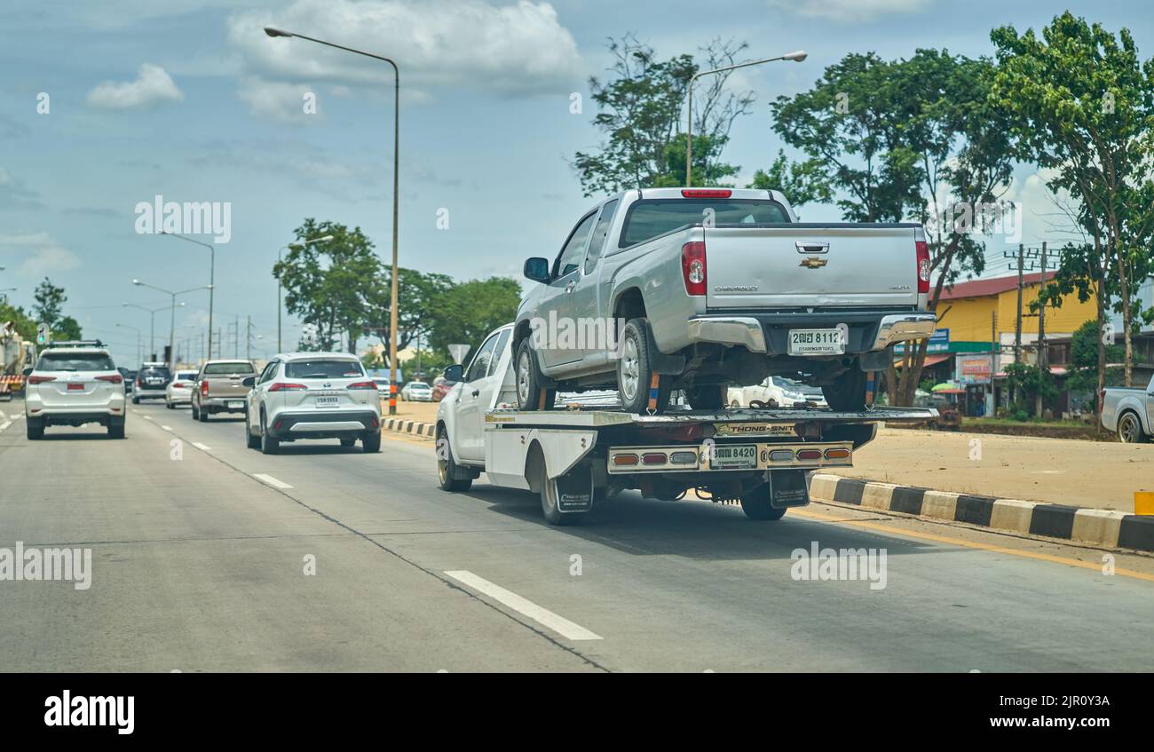 A pickup truck being transported on a flat bed transporter truck, taken in Thailand. Stock Photo